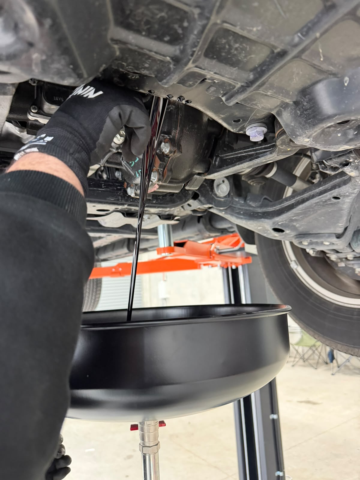 Oil being drained during a passenger vehicle service