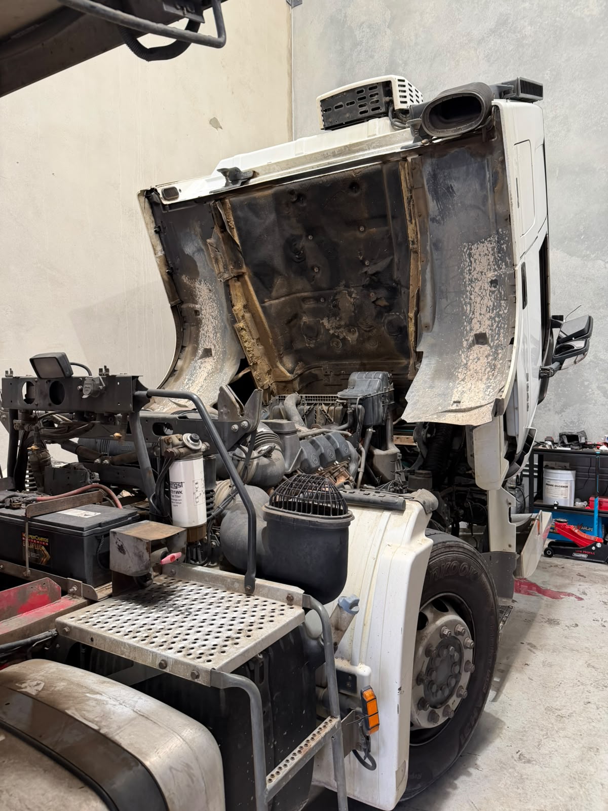 Japanese truck with the cab tilted for engine repairs